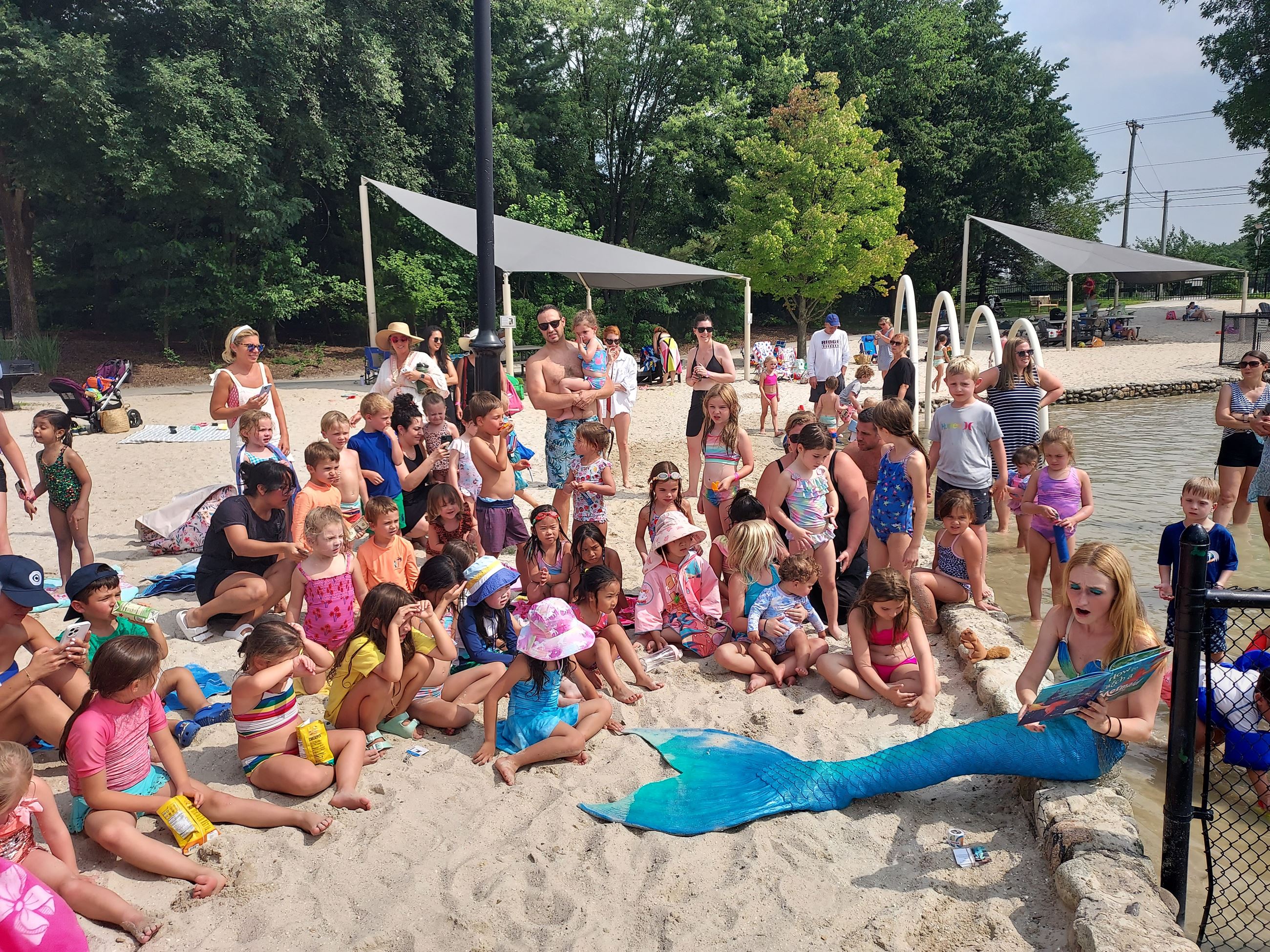 Mermaid Reading to Kids on beach